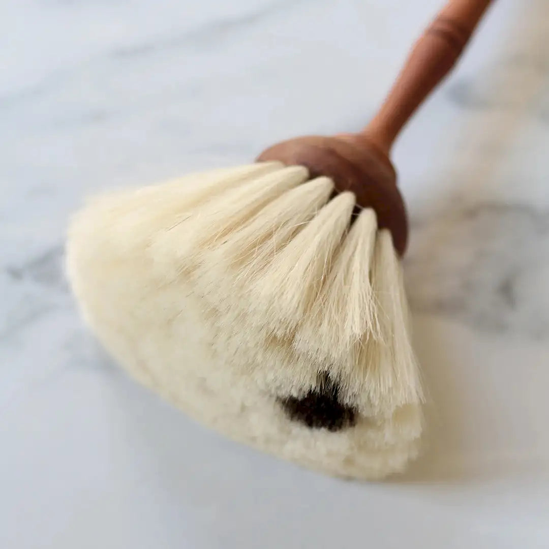 Soft brush removing dust from paper wall art corners