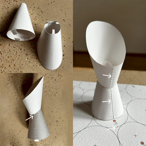 Creating smooth paper cones by gently rolling cardstock with a wooden rod on a soft surface for abstract paper wall decor.