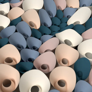 Contemporary decorative panel made from repeated paper cone units, forming a fluid and organic surface composition.